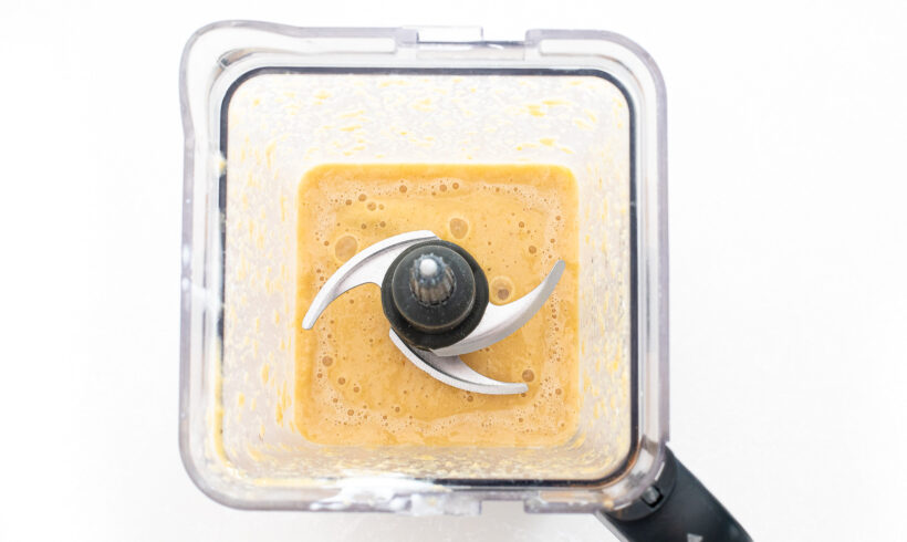 Overhead shot of blender with fruit mixture inside.