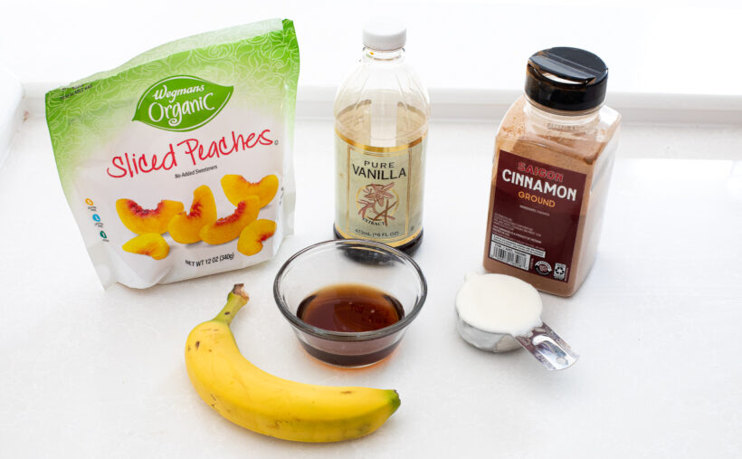 Ingredients needed for peach smoothies on a counter.