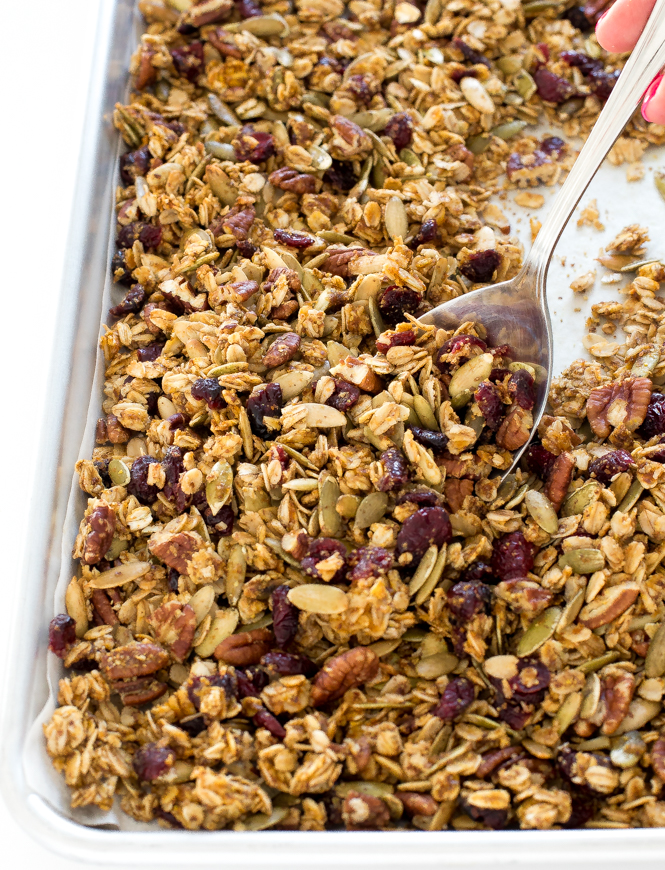 pecan pumpkin granola with cranberries on baking sheet