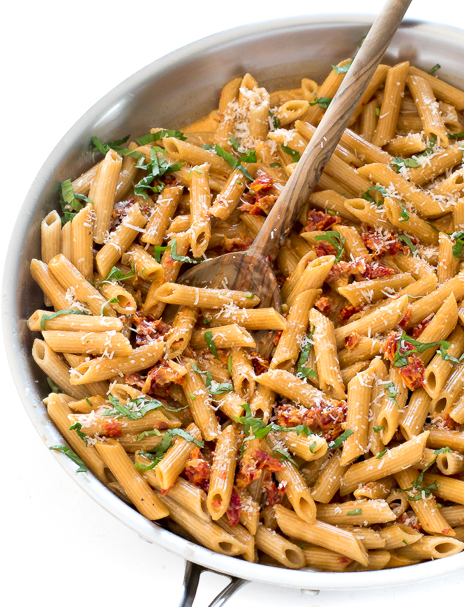 overhead shot of Penne alla Vodka in a large skillet with a wooden spoon
