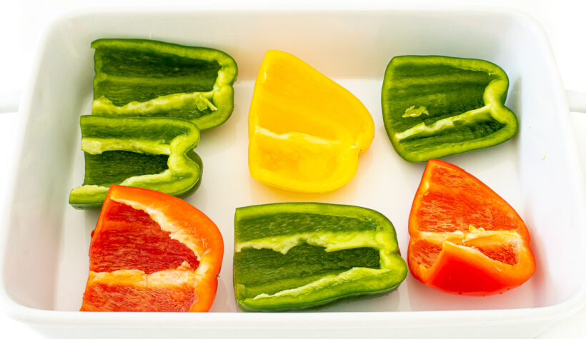 Havled peppers in a white baking dish.