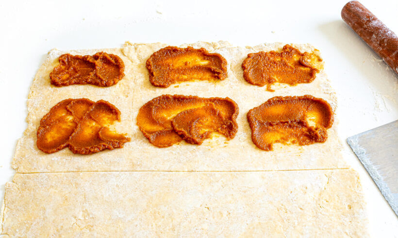 Pie crust spread with pumpkin filling.