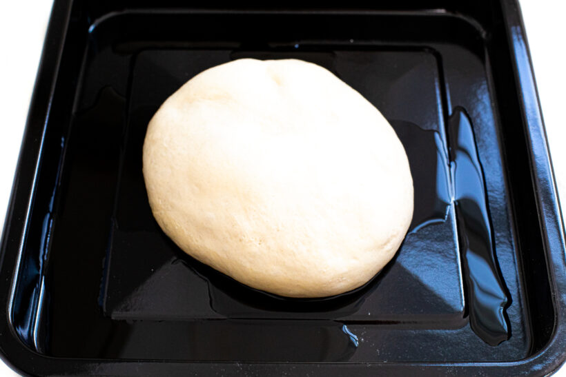 Dough ball in pizza pan.