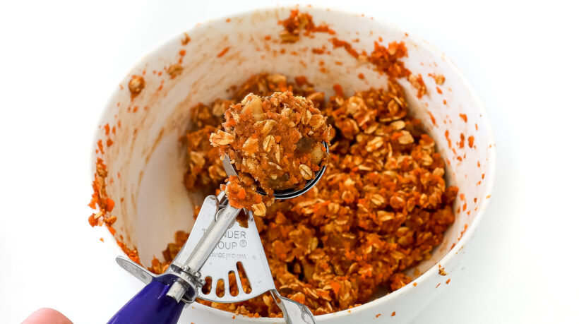 Using a cookie scoop to turn the mixture into balls.