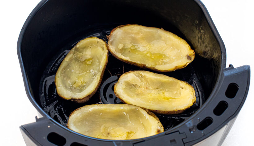 Potato skins in the air fryer basket. 