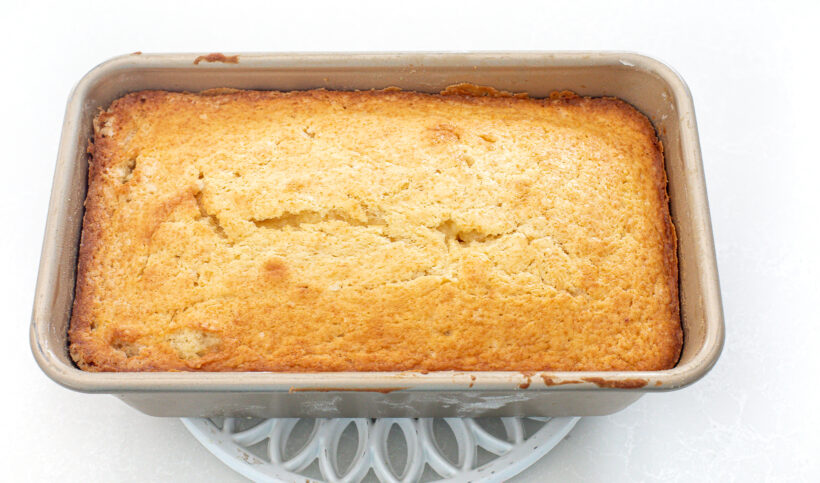 Loaf pan with pound cake in it after baking. 