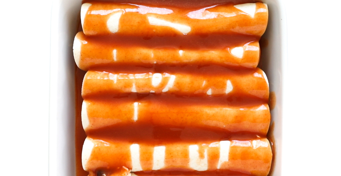 topping chicken enchiladas with enchilada sauce