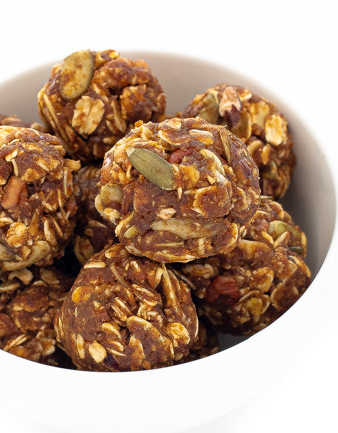 Pumpkin balls with oats and nuts piled in a white bowl.
