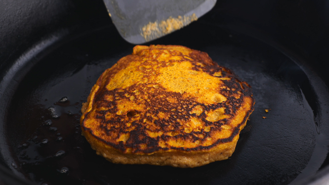 flipping pumpkin pancakes in cast iron skillet