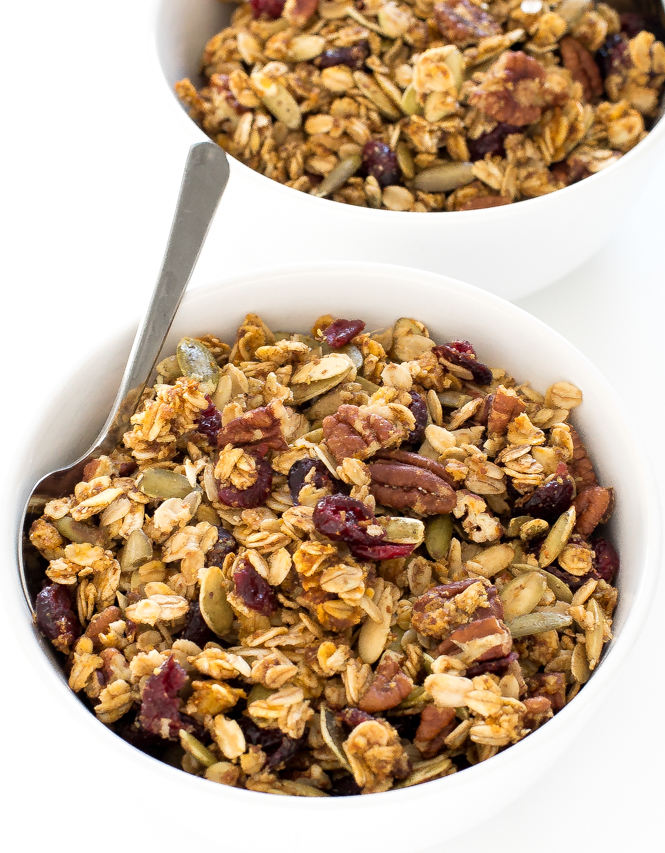 granola with a spoon in white bowl