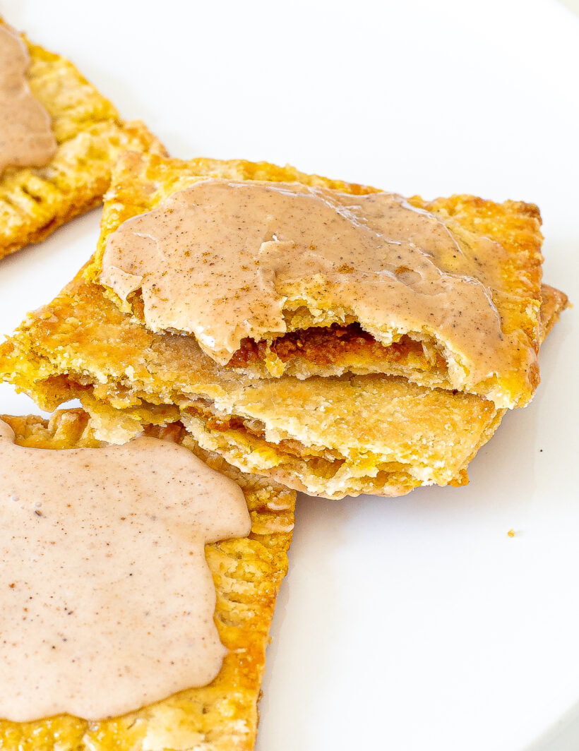 Pumpkin pie pop tart split in half to show pumpkin filling.