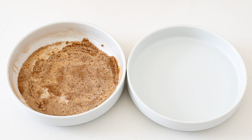 Pumpkin spice sugar and water in white bowls.