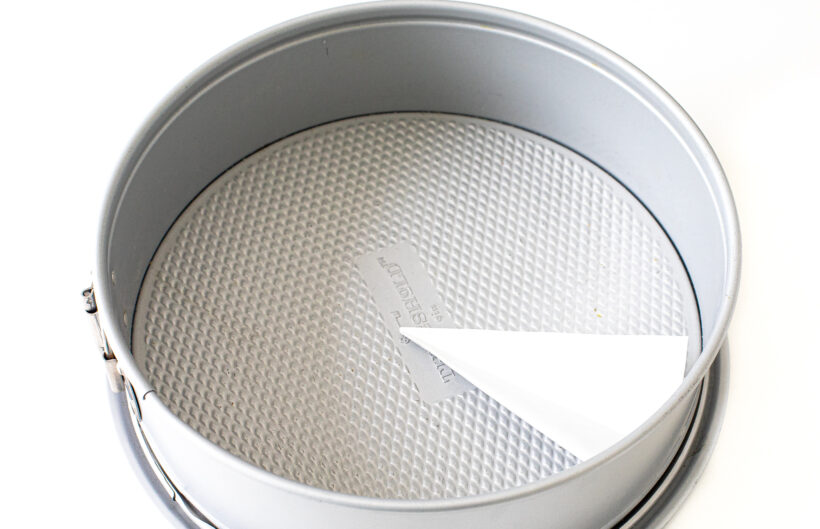 Springform pan lined with parchment paper.