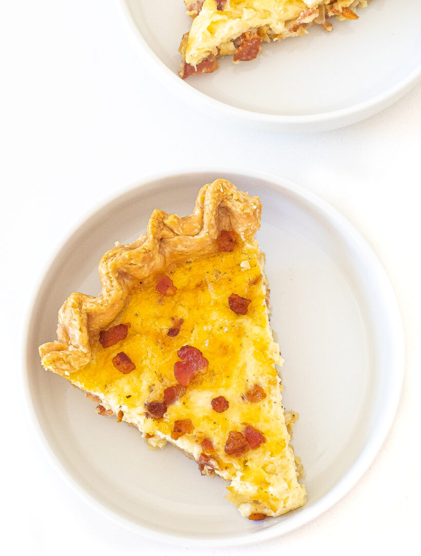 A top down view of quiche lorraine on a white plate.