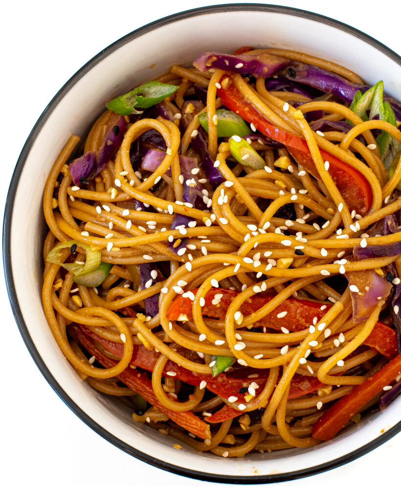 rainbow stir fry noodles in white bowl