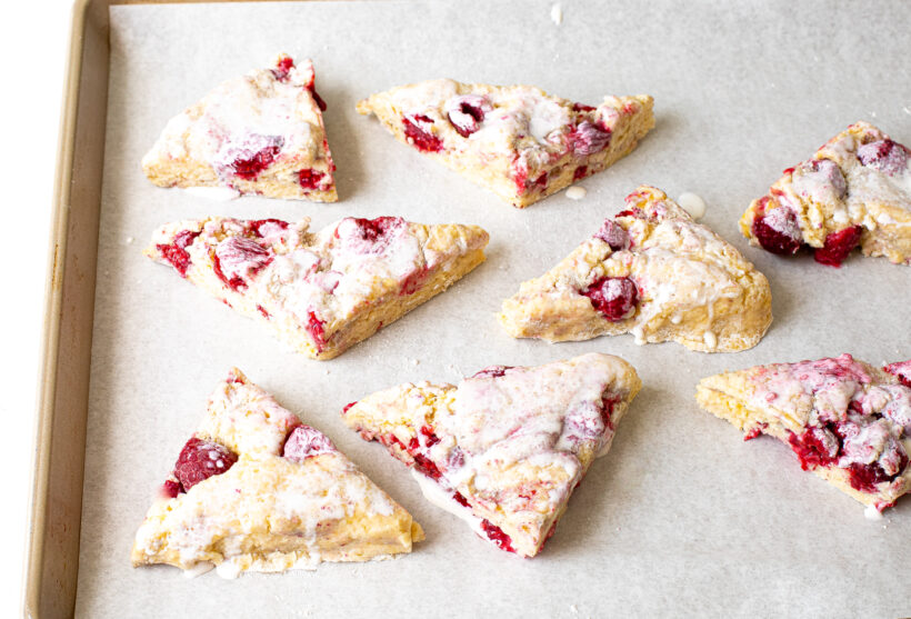 Raspberry Scones cut and placed on a baking sheet.