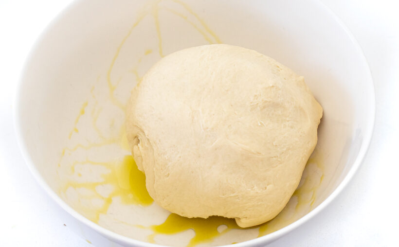 dough ball in grease white bowl