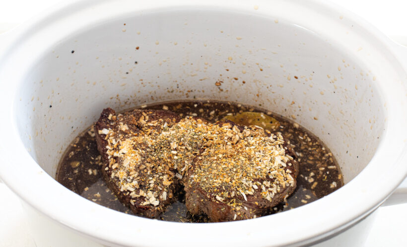 chuck roast and spices in the slow cooker