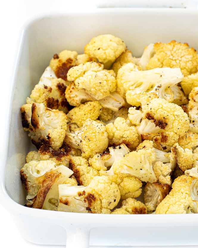 cauliflower in a white baking pan.