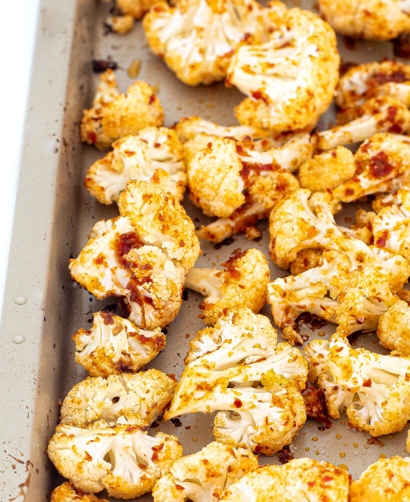 Up close shot of cauliflower on the sheet pan after being baked.