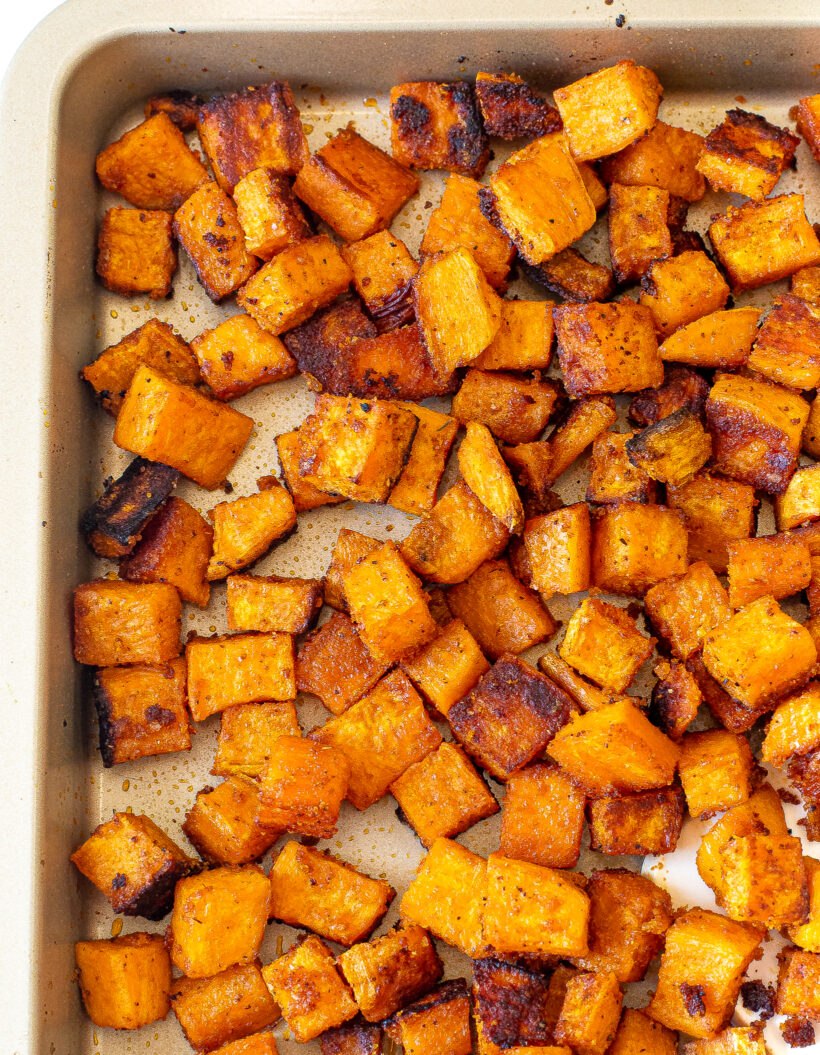 Roasted sweet potatoes on a sweet pan.