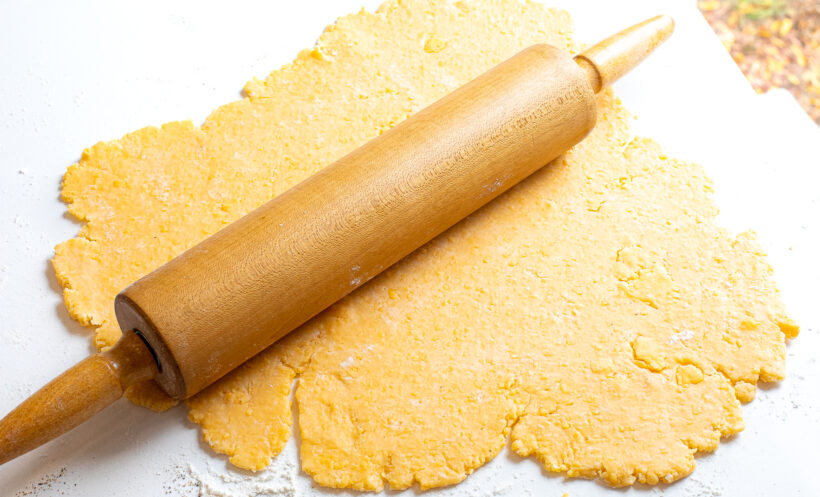Rolling out the goldfish dough using a rolling pin. 