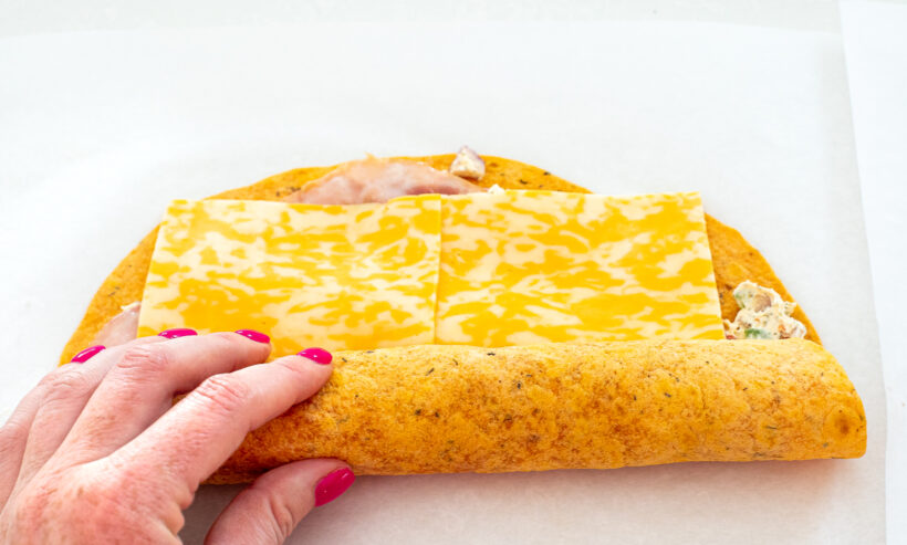 Hand rolling up the ham and cheese pinwheels.