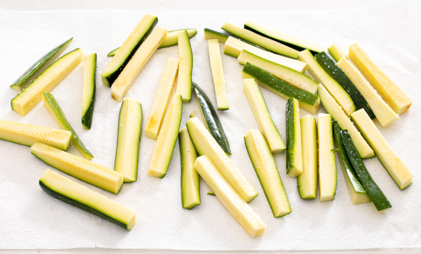 Zucchini cut into spears and placed on a paper towel.