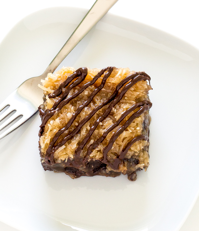 brownies topped with coconut topping drizzled with melted chocolate