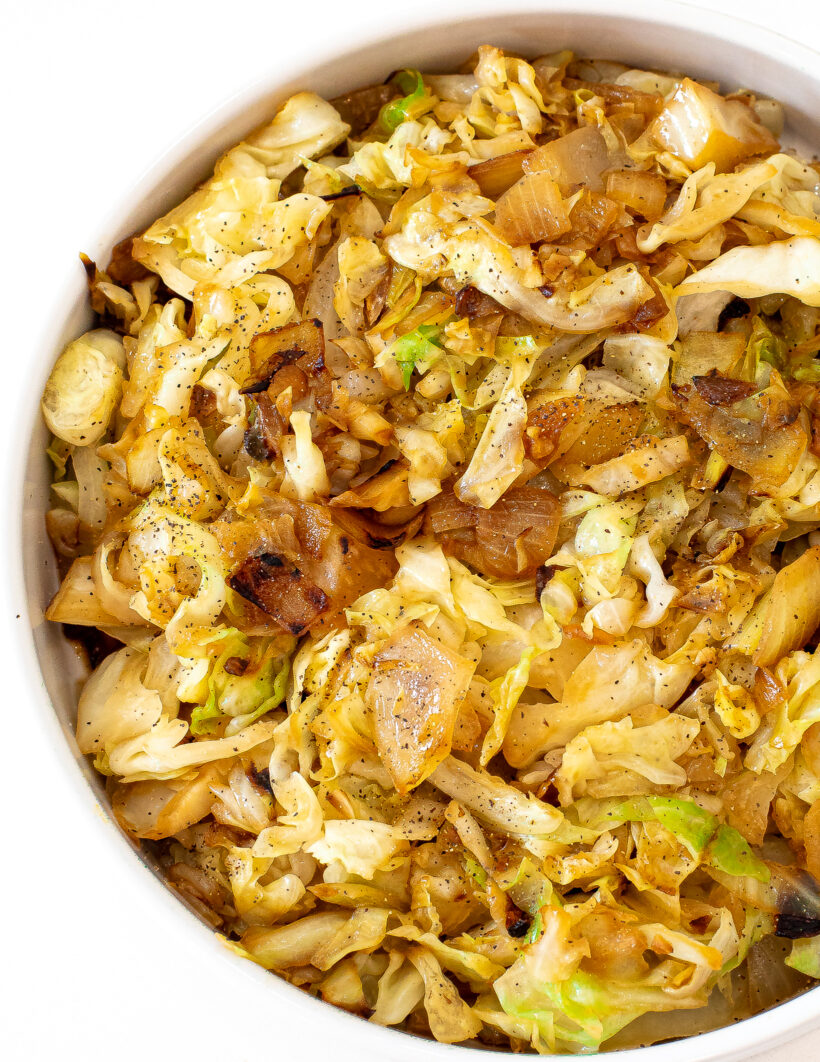 Overhead shot of sauteed cabbage served in a white bowl. 