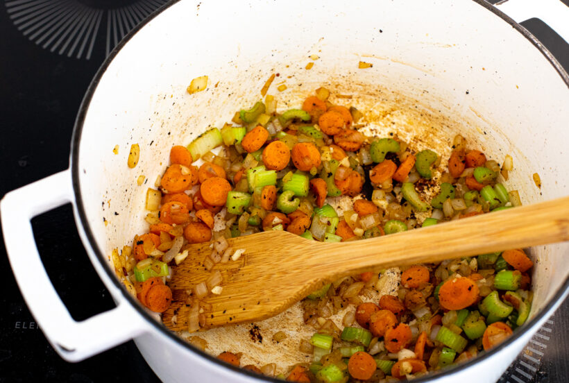 Onions, carrots and celery cooking in a large soup pot.