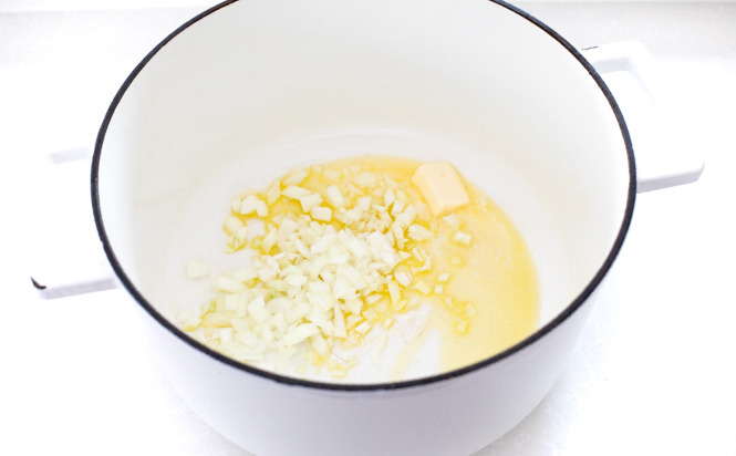 Sauteeing onion in butter and oil in cast iron white pot