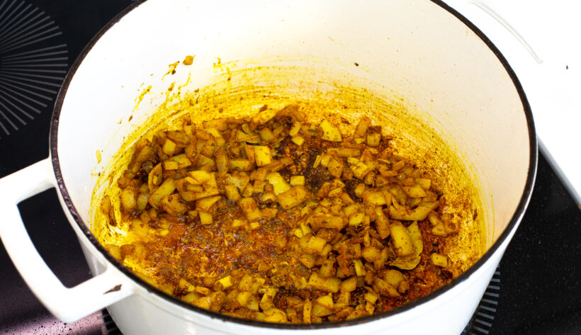 Onions sautéing in a large stock pot.