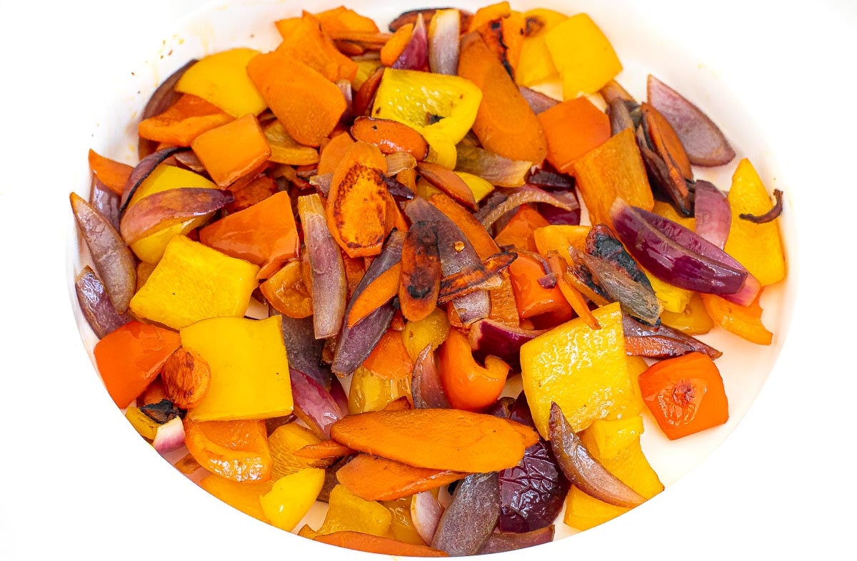 saut&eacute;ed carrots, bell peppers and onions on white plate