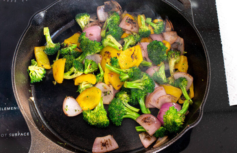 Stir fry vegetables in a skillet.