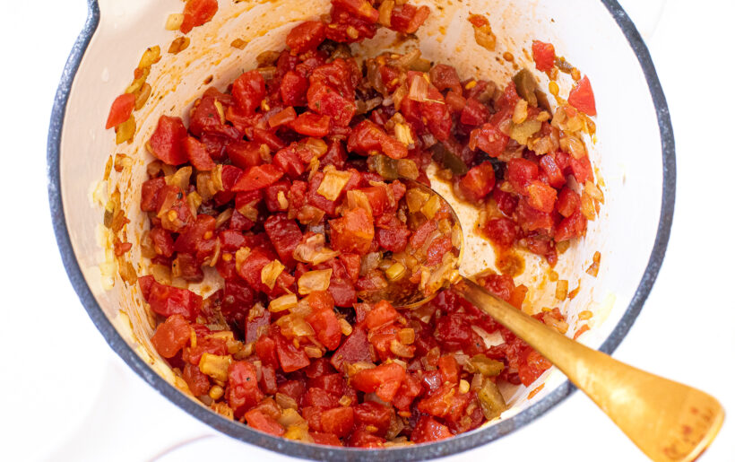 Diced tomatoes added to the frying pan.