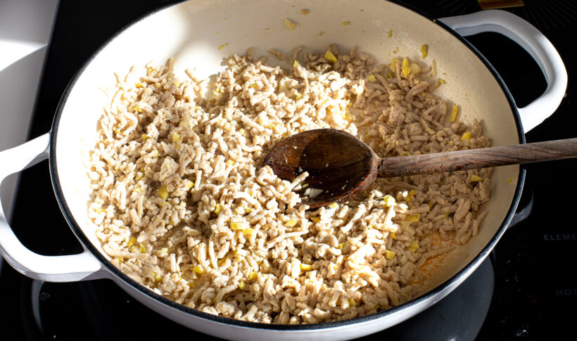 Ground chicken being cooked on the stove. 