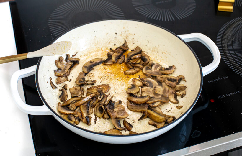 Cooked mushrooms in a skillet on the stove. 