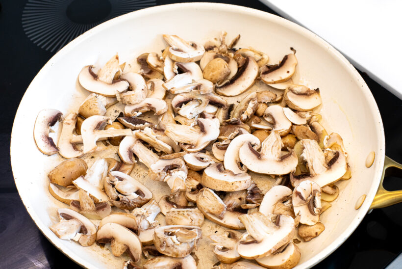 Sliced mushrooms in a skillet.