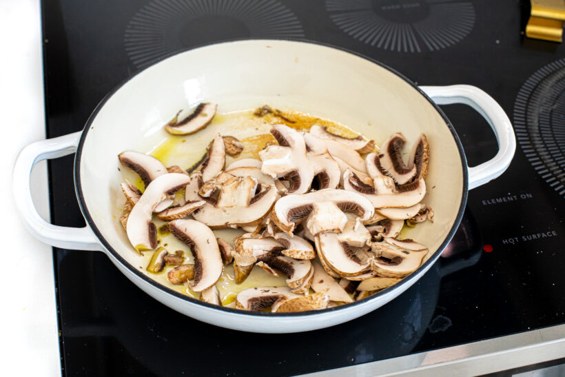 Mushrooms added to a skillet with olive oil. 