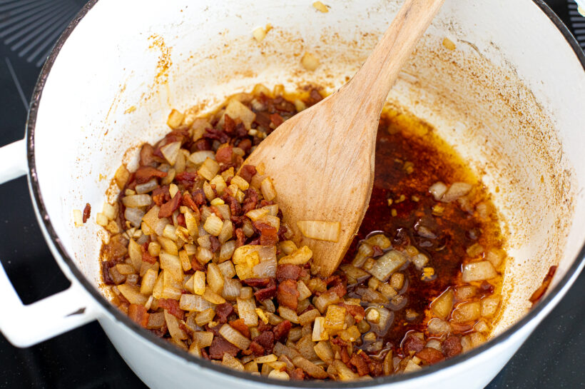 Onions and garlic added to the bacon.