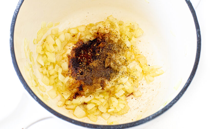 Sauted onion and seasonings in a frying pan.