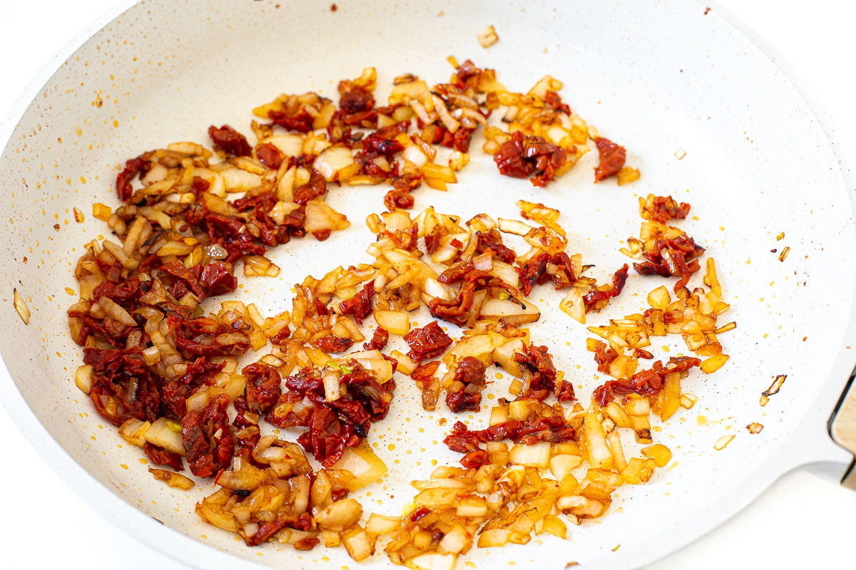 sautéing sun dried tomatoes and onions in large skillet