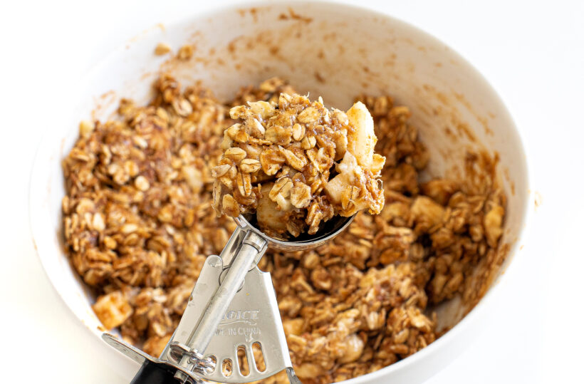Using a cookie scoop to portion out individual cookies.
