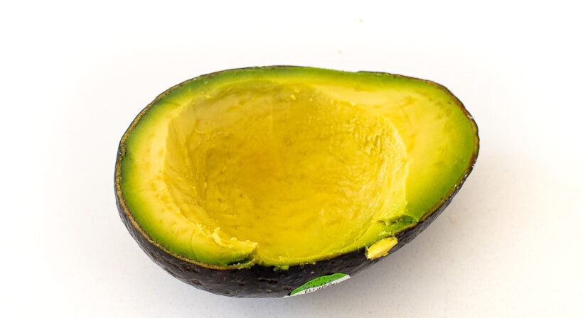Avocado half with some of it scooped out.