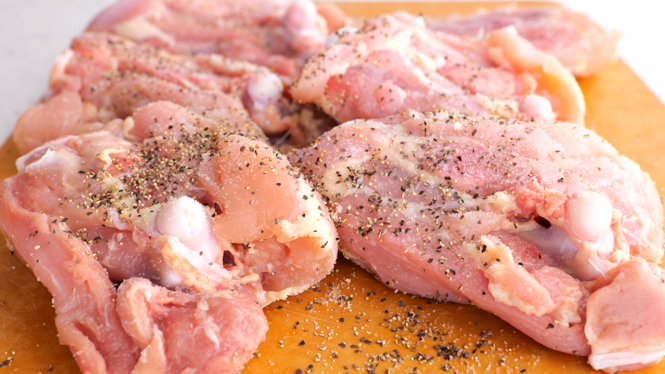 seasoning bone in chicken thighs with salt and pepper