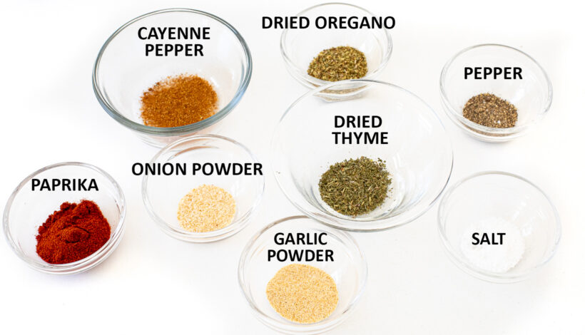 small clear jars with spices in them on counter top