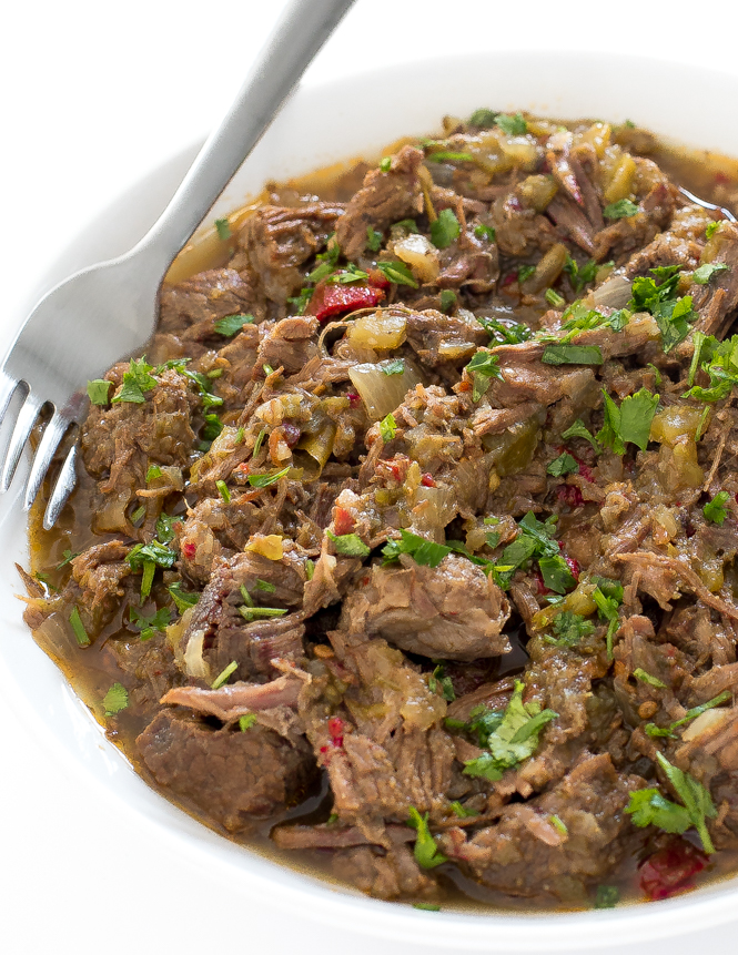 Instant Pot Barbacoa Beef in white bowl topped with fresh chopped cilantro