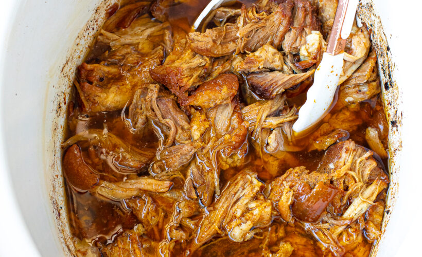 shredding crockpot pulled pork in slow cooker