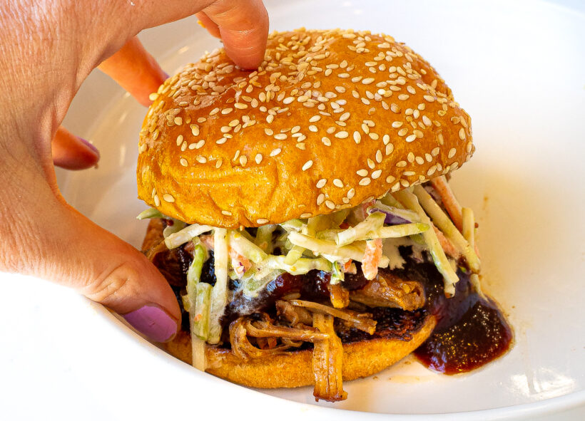 author grabbing slow cooker barbecue sandwich